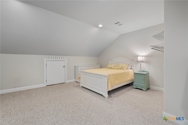 bedroom with lofted ceiling and light carpet