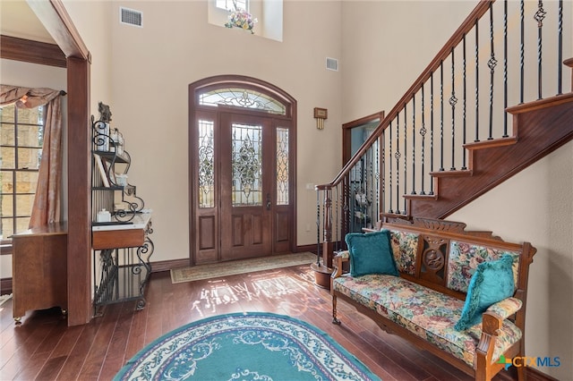 foyer featuring a high ceiling and dark wood-type flooring