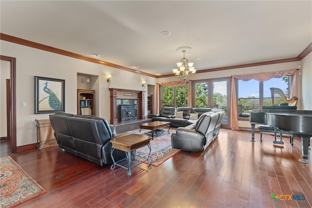 living room featuring a premium fireplace, ornamental molding, dark wood-type flooring, and a chandelier