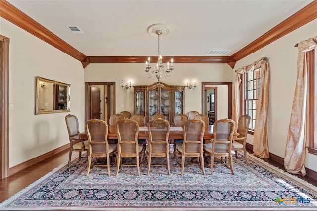 dining space featuring crown molding, a chandelier, and hardwood / wood-style flooring