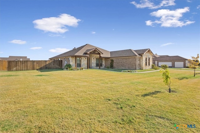 ranch-style home featuring a front lawn and a garage