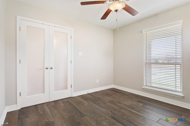 interior space featuring ceiling fan, a closet, and dark hardwood / wood-style flooring