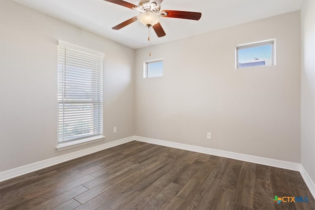 unfurnished room with plenty of natural light, dark wood-type flooring, and ceiling fan