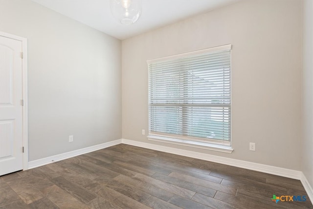 empty room featuring dark hardwood / wood-style flooring