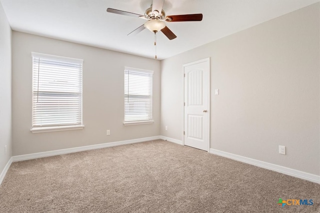 carpeted empty room featuring ceiling fan