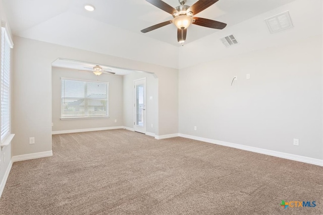 carpeted spare room featuring ceiling fan