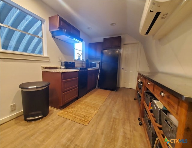 kitchen with black appliances, a center island, light hardwood / wood-style floors, and sink