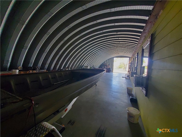 miscellaneous room with lofted ceiling and concrete floors