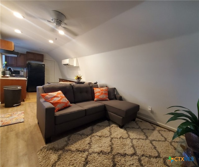 living room featuring ceiling fan, lofted ceiling, and a wall unit AC