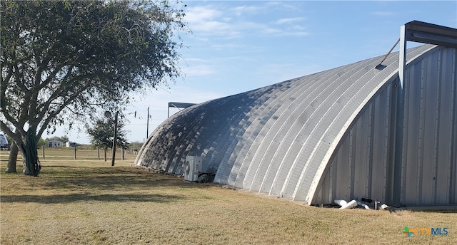 view of outbuilding with a lawn