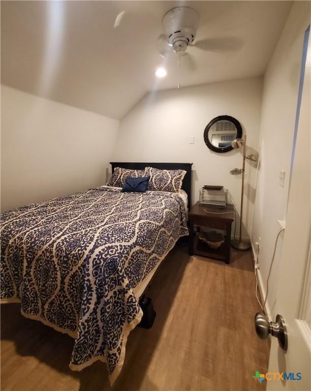 404 S 13th St, Seadrift, TX 77983 - bedroom with wood finished floors, vaulted ceiling, and a ceiling fan