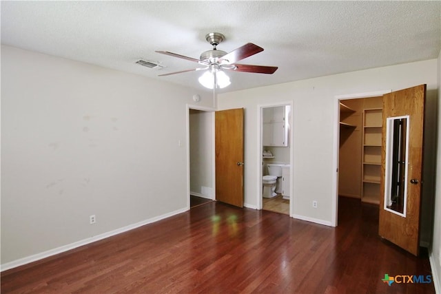 2110 Pamela Rd, Temple, TX 76502 - unfurnished bedroom with a spacious closet, wood finished floors, baseboards, a closet, and connected bathroom