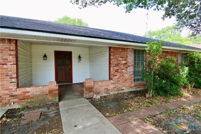 2110 Pamela Rd, Temple, TX 76502 - property entrance with brick siding, roof with shingles, and a porch