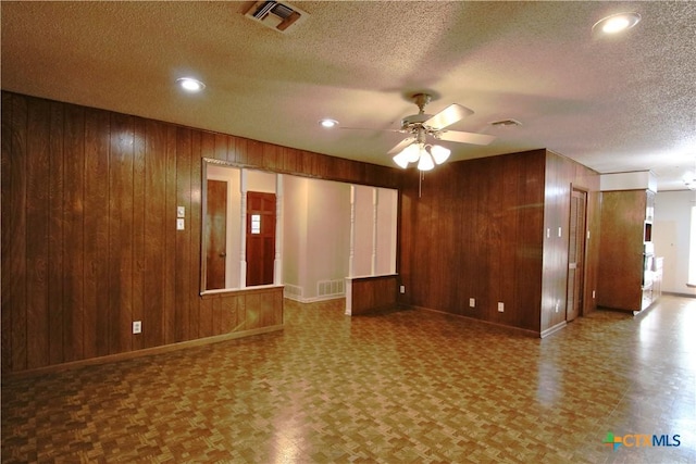 2110 Pamela Rd, Temple, TX 76502 - unfurnished room with baseboards, wood walls, ceiling fan, a textured ceiling, and recessed lighting