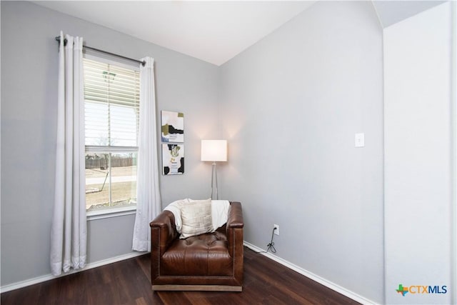 living area featuring baseboards and wood finished floors