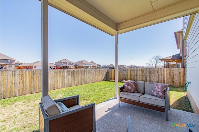 view of patio with outdoor lounge area, a fenced backyard, and a residential view