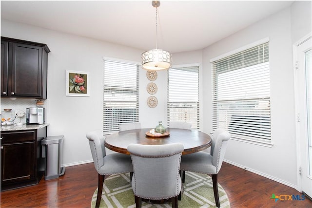 dining area with dark wood-style floors and baseboards