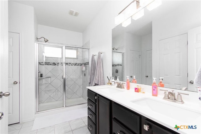 bathroom featuring double vanity, a sink, and a shower stall