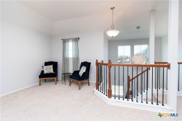 sitting room with carpet floors, an upstairs landing, and baseboards