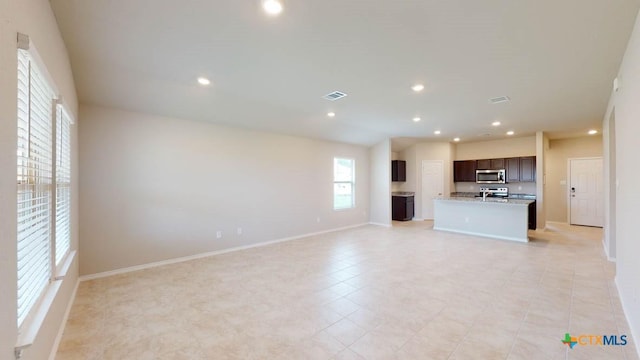 unfurnished living room featuring recessed lighting, visible vents, baseboards, and light tile patterned floors