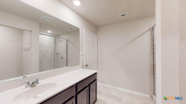 full bathroom with vanity, a shower stall, and visible vents