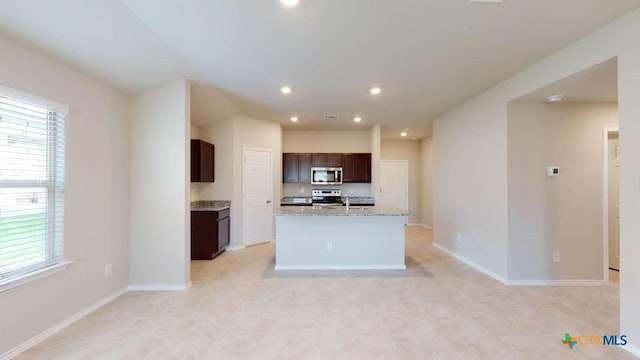 kitchen with stainless steel appliances, recessed lighting, a wealth of natural light, and dark brown cabinetry