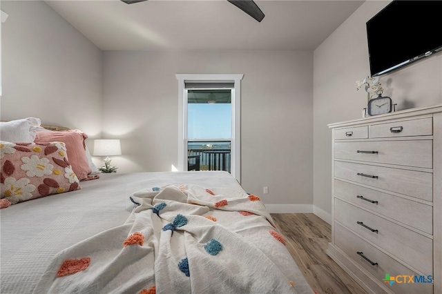 121 Bufflehead Ln, Rockport, TX 78382 - bedroom with wood finished floors, baseboards, and a ceiling fan
