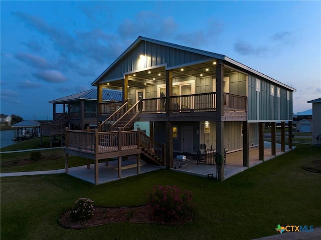 121 Bufflehead Ln, Rockport, TX 78382 - rear view of property featuring a patio area, board and batten siding, a yard, and stairway