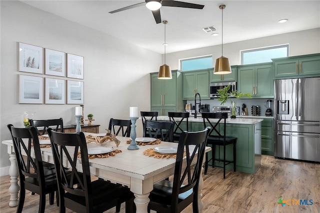 121 Bufflehead Ln, Rockport, TX 78382 - dining area with ceiling fan and light wood-style flooring