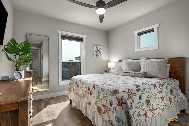 121 Bufflehead Ln, Rockport, TX 78382 - bedroom featuring dark wood-style floors, a ceiling fan, and baseboards