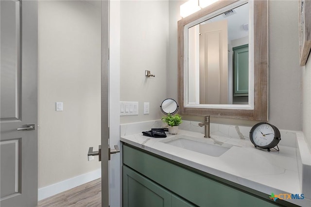 121 Bufflehead Ln, Rockport, TX 78382 - bathroom with vanity, wood finished floors, and baseboards