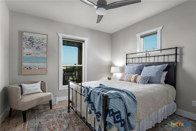 121 Bufflehead Ln, Rockport, TX 78382 - bedroom featuring baseboards, wood finished floors, and a ceiling fan