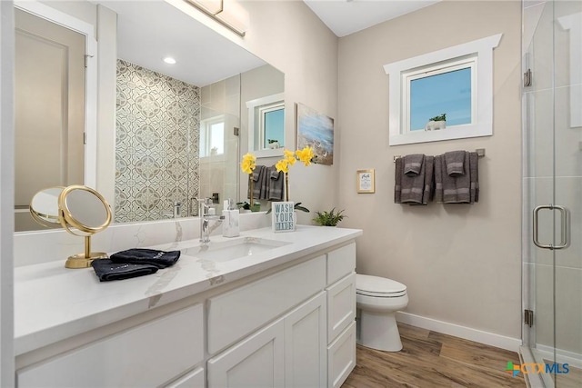 121 Bufflehead Ln, Rockport, TX 78382 - bathroom featuring a shower stall, toilet, wood finished floors, vanity, and baseboards