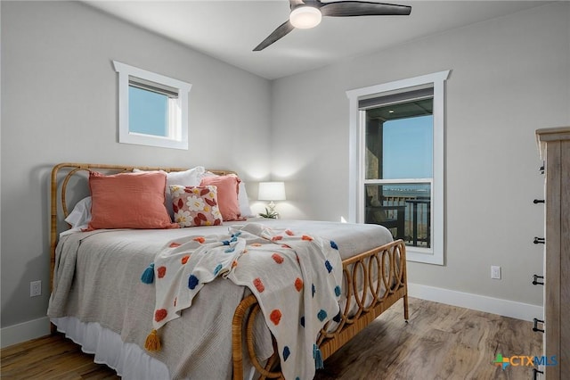 121 Bufflehead Ln, Rockport, TX 78382 - bedroom featuring wood finished floors, baseboards, and a ceiling fan