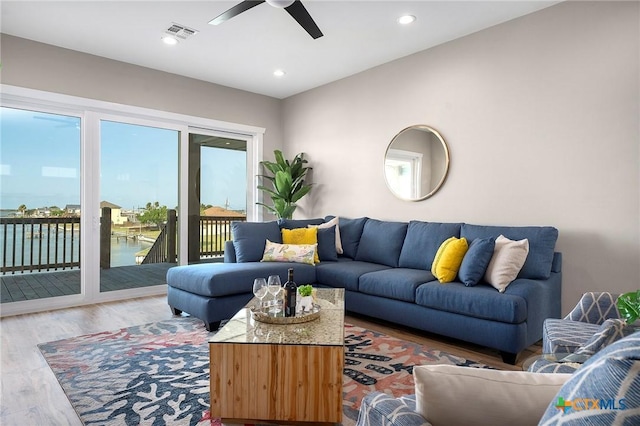 121 Bufflehead Ln, Rockport, TX 78382 - living area featuring ceiling fan, wood finished floors, a water view, and recessed lighting