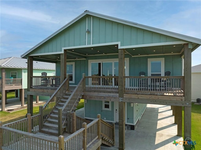 121 Bufflehead Ln, Rockport, TX 78382 - coastal inspired home with stairway and board and batten siding