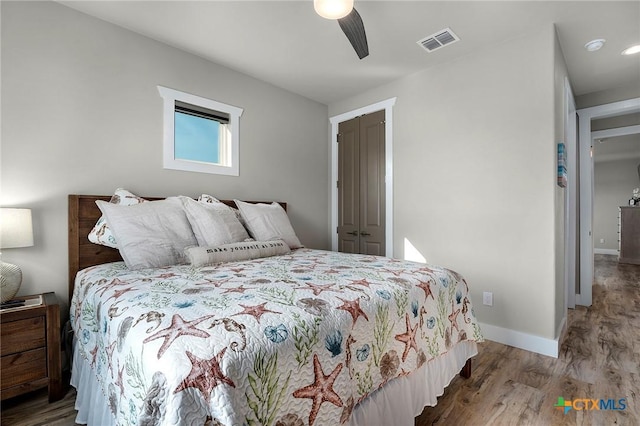 121 Bufflehead Ln, Rockport, TX 78382 - bedroom with wood finished floors, baseboards, a ceiling fan, and a closet