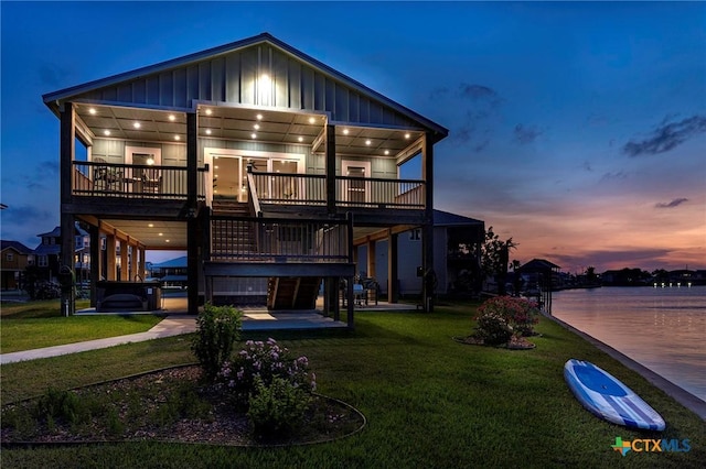 121 Bufflehead Ln, Rockport, TX 78382 - back of property featuring board and batten siding, a lawn, a patio, and a deck