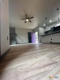 unfurnished living room featuring a ceiling fan