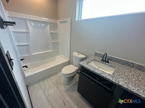 full bathroom with tub / shower combination, vanity, and toilet