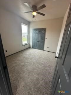 unfurnished bedroom featuring a ceiling fan and carpet flooring