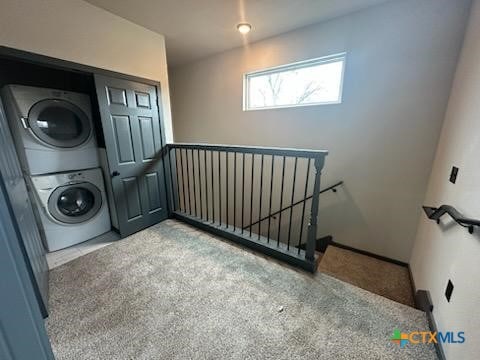 washroom with stacked washer / dryer and laundry area