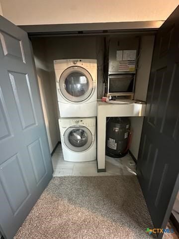 clothes washing area with laundry area and stacked washing maching and dryer