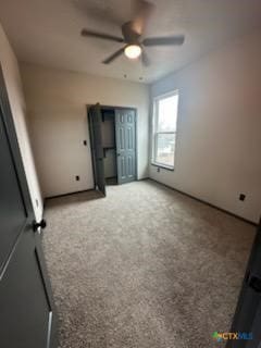 unfurnished bedroom featuring carpet floors and a ceiling fan