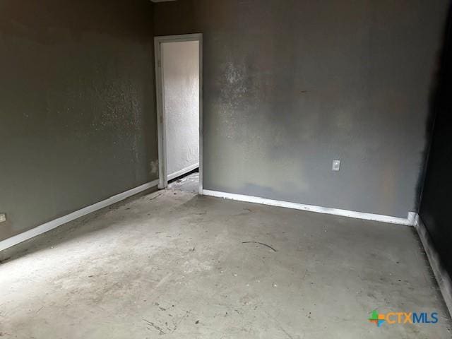 unfurnished room with concrete floors