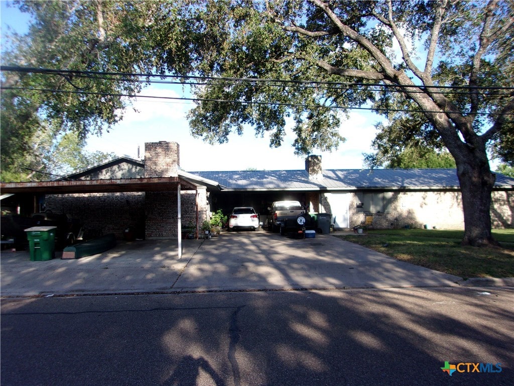 view of front of home with a carport