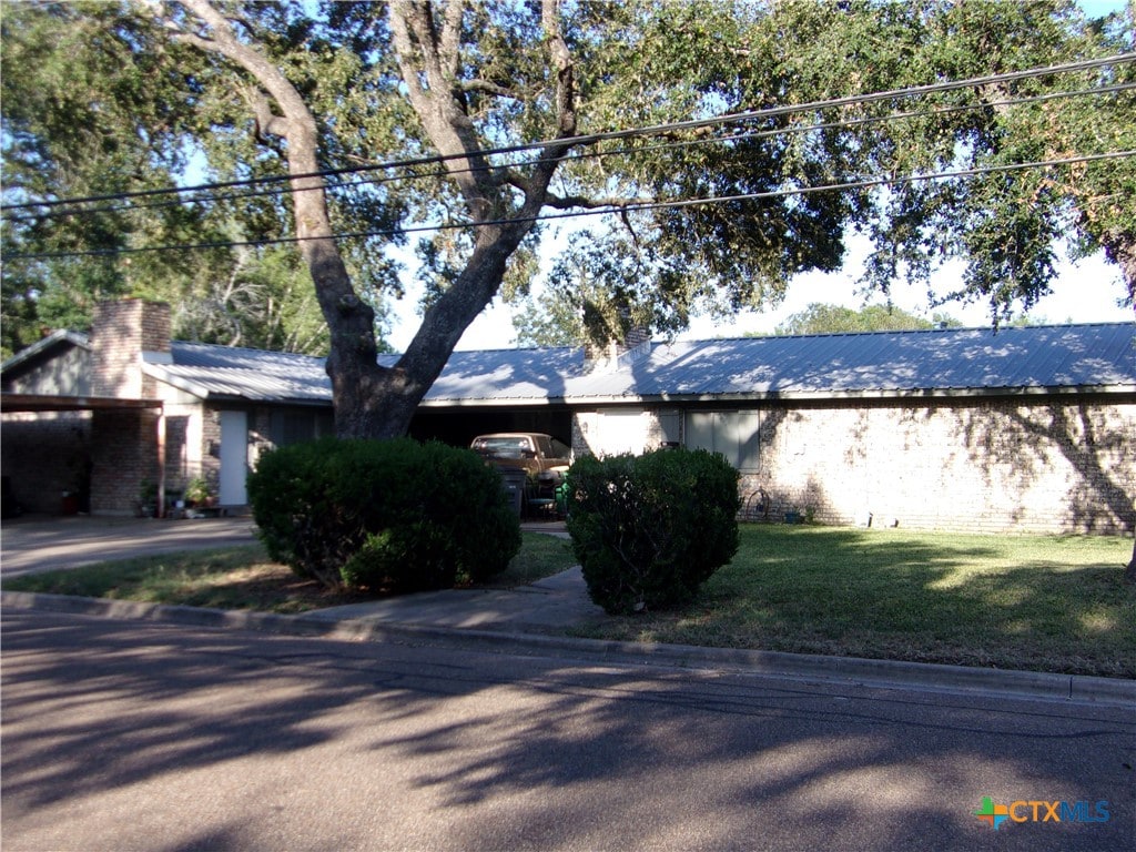 view of side of property with a lawn