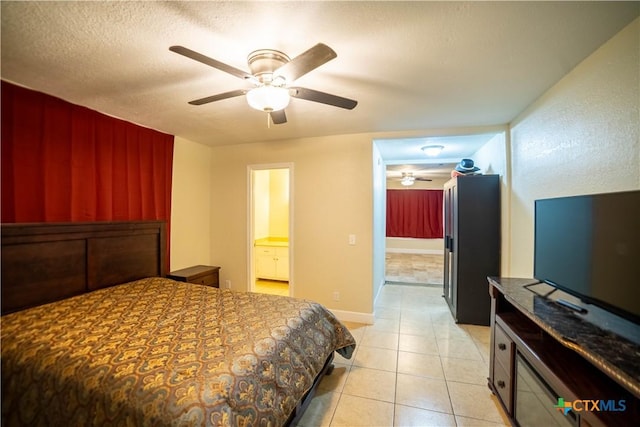 1906 N 60th St, Killeen, TX 76543 - bedroom with light tile patterned floors, ensuite bath, and a ceiling fan