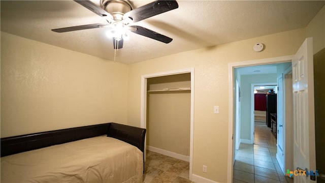 1906 N 60th St, Killeen, TX 76543 - unfurnished bedroom featuring tile patterned floors, a ceiling fan, and baseboards