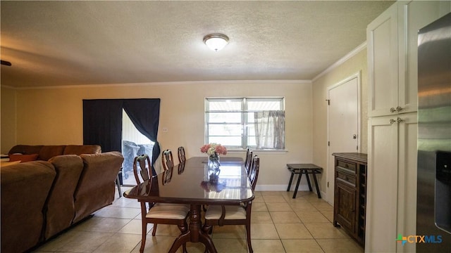 1906 N 60th St, Killeen, TX 76543 - dining space featuring crown molding, a textured ceiling, light tile patterned floors, and baseboards